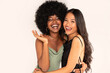 Beauty asian woman posing with her friend with afro hairstyle. Cheerful, elegant girls standing together, looking at the camera and smiling happily