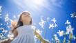 A beautiful little girl in a bluebell flowers field against a blue sky