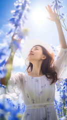 Poster - Portrait of beautiful girl in field with bluebell flowers, sky background