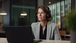 © Usman - Happy professional mature female hr manager, smiling mature mid aged business woman in office wearing earbud looking at laptop computer having hybrid conference work meeting or remote job interview