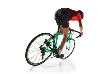 Wall Mural - Young man, athlete, cyclist in uniform and helmet, riding bicycle isolated over white studio background. Training