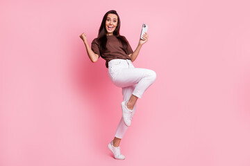full body photo of brunette hair girl raised fist up celebration received transaction using phone is