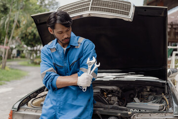 car engine service concept Car mechanic checks car engine with car repair inspection, car service and maintenance, checks oil in car engine.