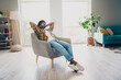 © deagreez - Photo of nice confident man boss sitting in soft armchair holding hands behind head enjoying relax rest weekend indoors