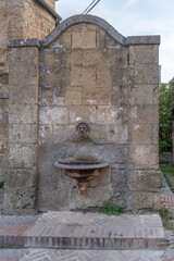 Wall Mural - old tuff monumental fountain at medieval village, Sovana, Italy