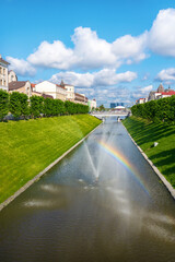 Wall Mural - Kazan, Russia, June 1, 2023: view of the Bulak water canal with rainbow, bridges and fountains in the city centre on a sunny summer day. View towards the Kazanka River