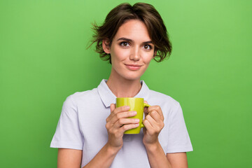 Sticker - Photo of pretty adorable girl wearing stylish clothes hand hold cup sweet cacao isolated on green color background