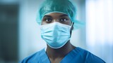 Fototapeta Lawenda - Portrait of a Doctor in Surgical Mask with Colleagues in Background