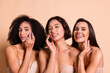 © deagreez - Studio photo of cheerful sweet ladies dressed lingerie no filter skin applying cream isolated pastel beige color background