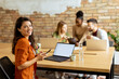 © BGStock72 - Business woman working on laptop with her young multiethnic startup team working in the modern office