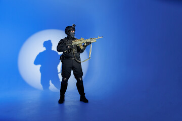 Wall Mural - Soldier in black uniforms with weapon in studio. Concept Military warrior army tactical force to fight crime in city