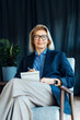 © okrasiuk - Portrait of smiling 50's stylish, confident mature businesswoman, middle aged company ceo director, experienced senior female professional, business coach team leader in modern office. Female leader