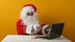 © Oksava - Santa Claus with money dollars and laptop.