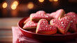 © olympuscat - Red homemade heart-shaped cookies decorated with white icing for Valentine's Day on the table with festive background
