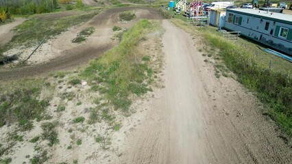 Wall Mural - dirt bike riders on track clear skies out of focus with grain motorbikes mx