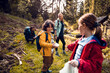 © Marko Geber - Children cleaning forest on nature hike with parents