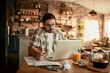 © Davor - Serious young man working from home on laptop
