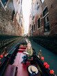A young girl relaxes on a gondola, her gaze captivated by the sunset over the waters of Venice's Grand Canal