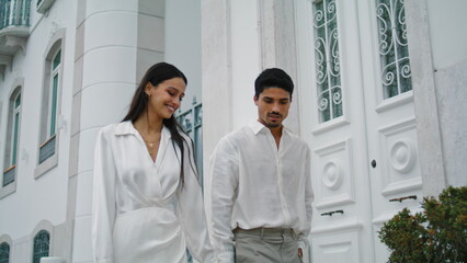 Wall Mural - Romantic spouses walking city. Couple enjoying pleasant evening date strolling