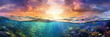 Long banner with underwater world and vivid sunset sky. Transparent deep water of the ocean or sea with rocks, fish and plants.
