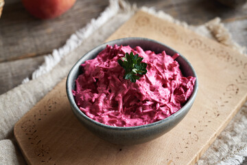 Wall Mural - Vegetable salad made of fresh red beet and sour cream on a table