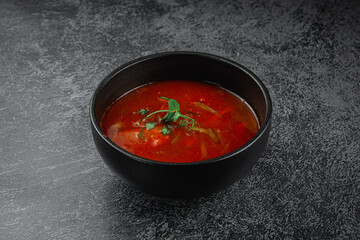 Wall Mural - Traditional Russian and Ukrainian cuisine, appetizing red borscht on a dark background