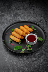 Sticker - Cheese nuggets, beer appetizers in dark plate