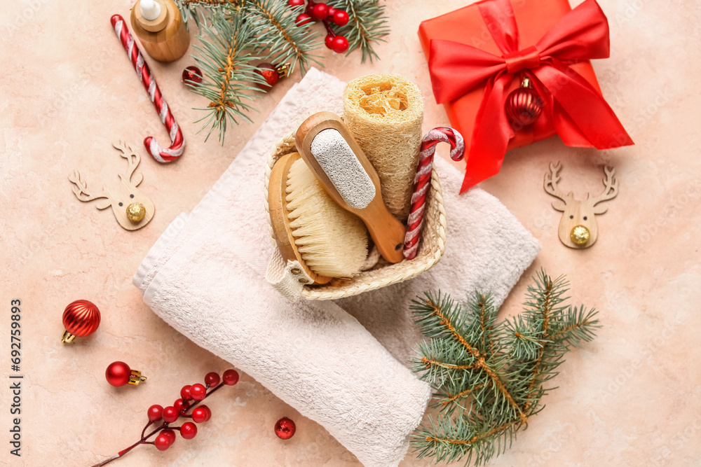 Beautiful spa composition with Christmas decorations and gift box on color background