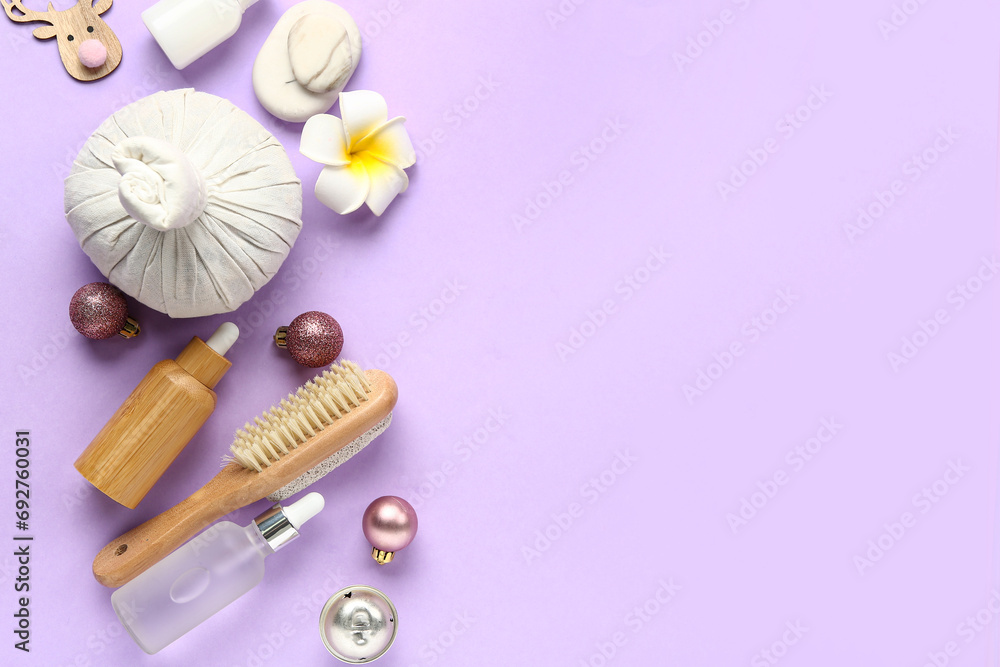 Composition with spa accessories and Christmas decorations on lilac background