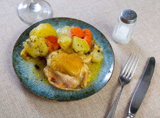 Canvas Print - Stewed piece of chicken, potato and chopped carrot with sauce served in a plate
