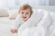 © Kowit - Cute and Happy child looking out of the white blanket. Copy space.