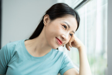 Wall Mural - Photo of young Asian woman at home