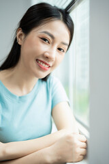 Wall Mural - Photo of young Asian woman at home