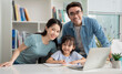 © Timeimage - Photo of young Asian family studying together at home
