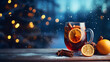 Hot mulled wine with cinnamon and orange slice, old rustic wooden plank against background.