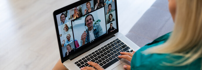 Businesswoman making video call to business partner using laptop. Close-up rear view of young woman having discussion with corporate client. Remote job interview, consultation, human resources concept