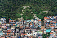 Colorful Favelas Climbing Steep Hillsides In Distant Cityscape
