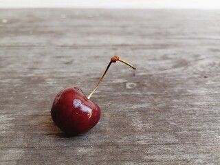 Wall Mural - Fresh red cherry fruit on table wood background