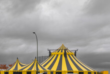 Bright Yellow Exterior Of A Circus And A Cloudy Gray Sky