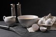 © New Africa - Metal whisk and dough ingredients on dark grey table
