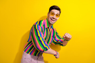 Canvas Print - Photo of young macho boyfriend having fun at discotheque comes crazy using hands on dancehall isolated over yellow color background