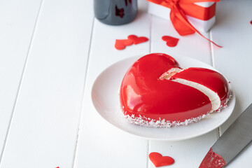 Wall Mural - heart shaped glazed valentine cake and flowers on wooden table