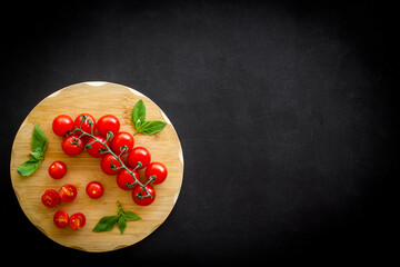 Wall Mural - Tomatoes and basil on wooden board, top view. Cooking background