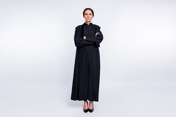 Sticker - Full size photo of serious confident woman judge attorney with folded hands wear black robe isolated on white color background