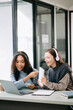 © Nuttapong punna - Two Attractive young female college students working on the school project using computer and tablet together, enjoy talking and headphones having a video chat.