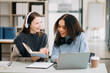 © Nuttapong punna - Two Attractive young female college students working on the school project using computer and tablet together, enjoy talking and headphones having a video chat.