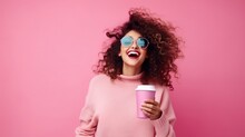 Exuberant Woman In A Pastel Pink Sweater And Blue Sunglasses, Laughing With Joy, Holding A Coffee Cup Against A Vibrant Pink Background..
