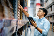 © sirichai - Businessman or supervisor uses a digital tablet to check the stock inventory in furniture large warehouses, a Smart warehouse management system, supply chain and logistic network technology concept.
