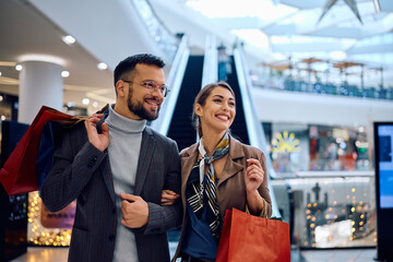 Wall Mural - Happy couple spending their day in shopping at mall.