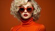 portrait of a orange dressed blonde retro style woman with glasses and red lips